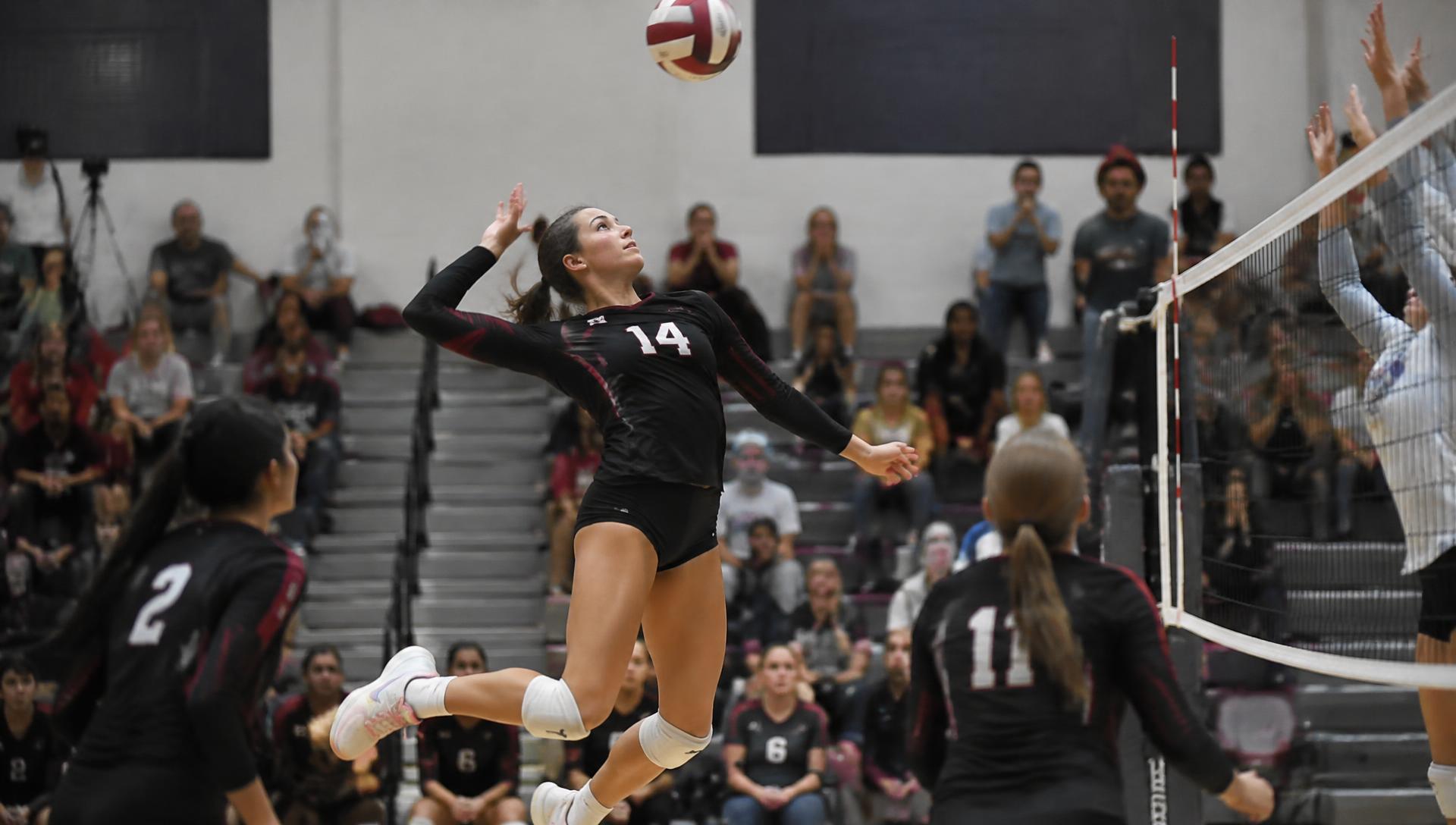 Youth volleyball player jumping for a spike during a game